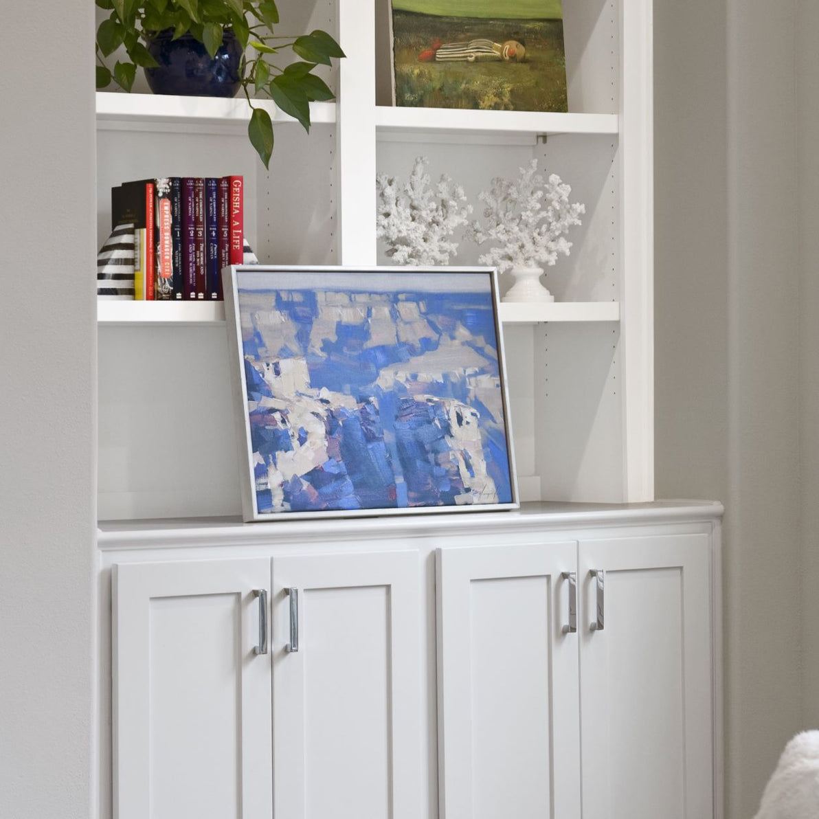 An artfully decorated bookshelf at the home of a UGallery client