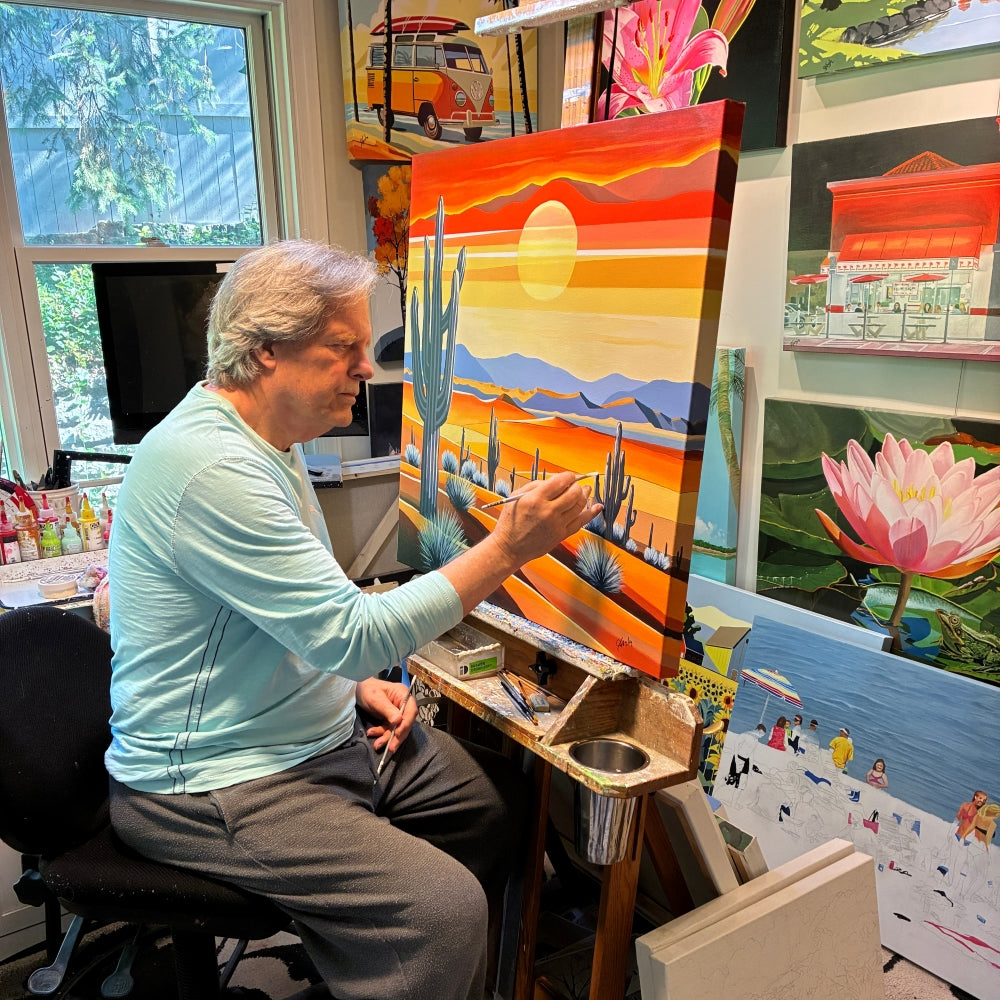 UGallery artist John Jaster painting a desert landscape in his studio