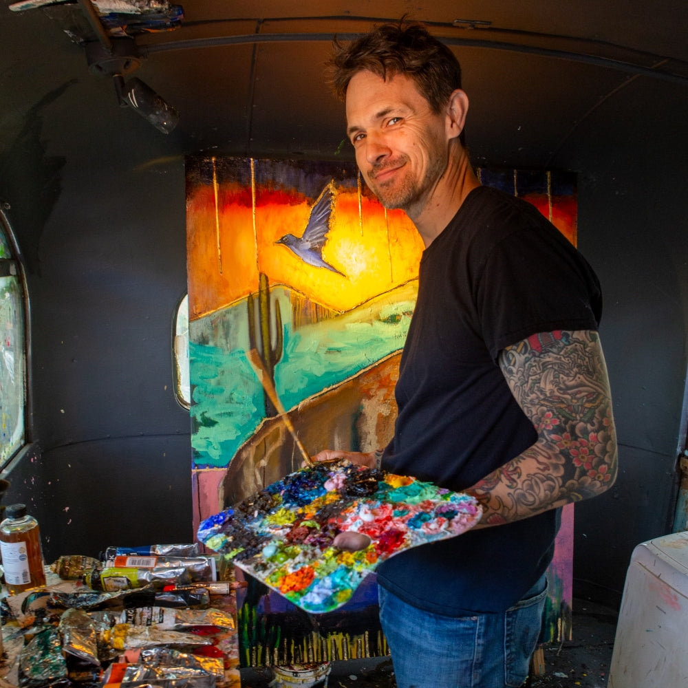 UGallery artist Scott Dykema holding a palette in his studio