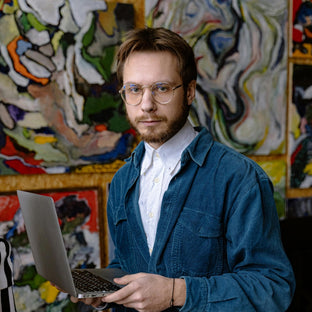  Portrait of a man holding a laptop on art background. Photo courtesy of Antoni Shkraba Studio 