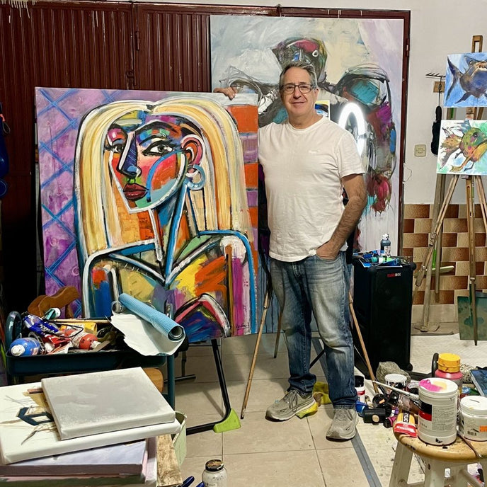  UGallery Allen Wittert standing next to his portrait painting of a woman 