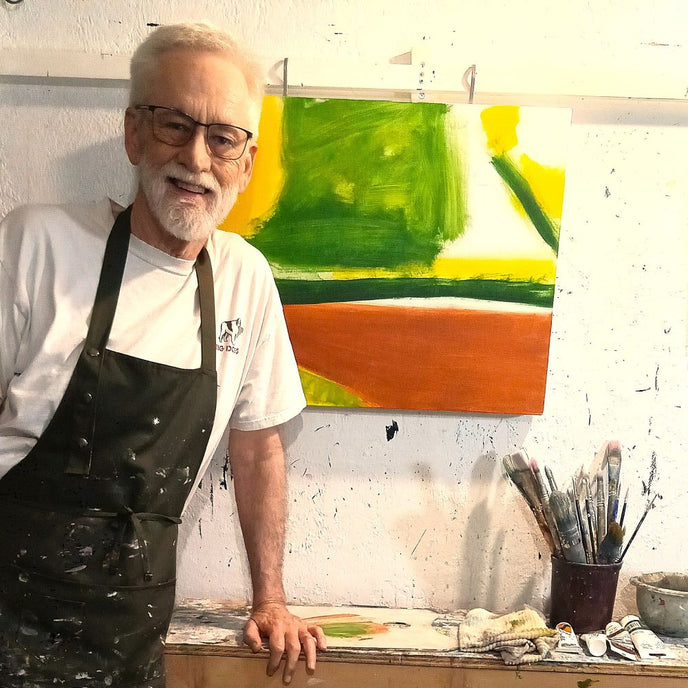  UGallery artist Benjamin Thomas beside one of his abstract paintings 