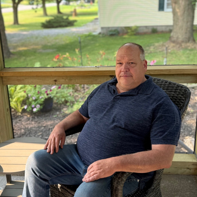  UGallery artist David Thelen sitting on a porch 