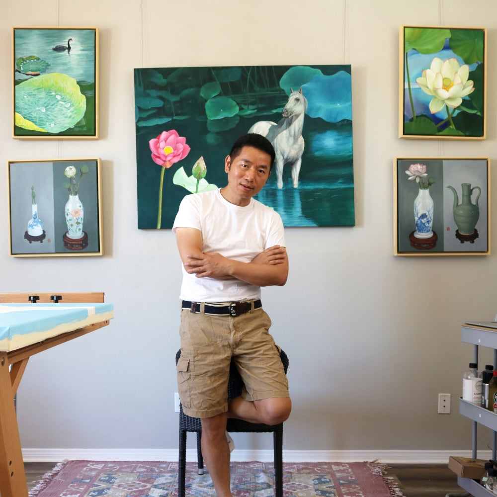  UGallery artist Guigen Zha with his paintings in the background 