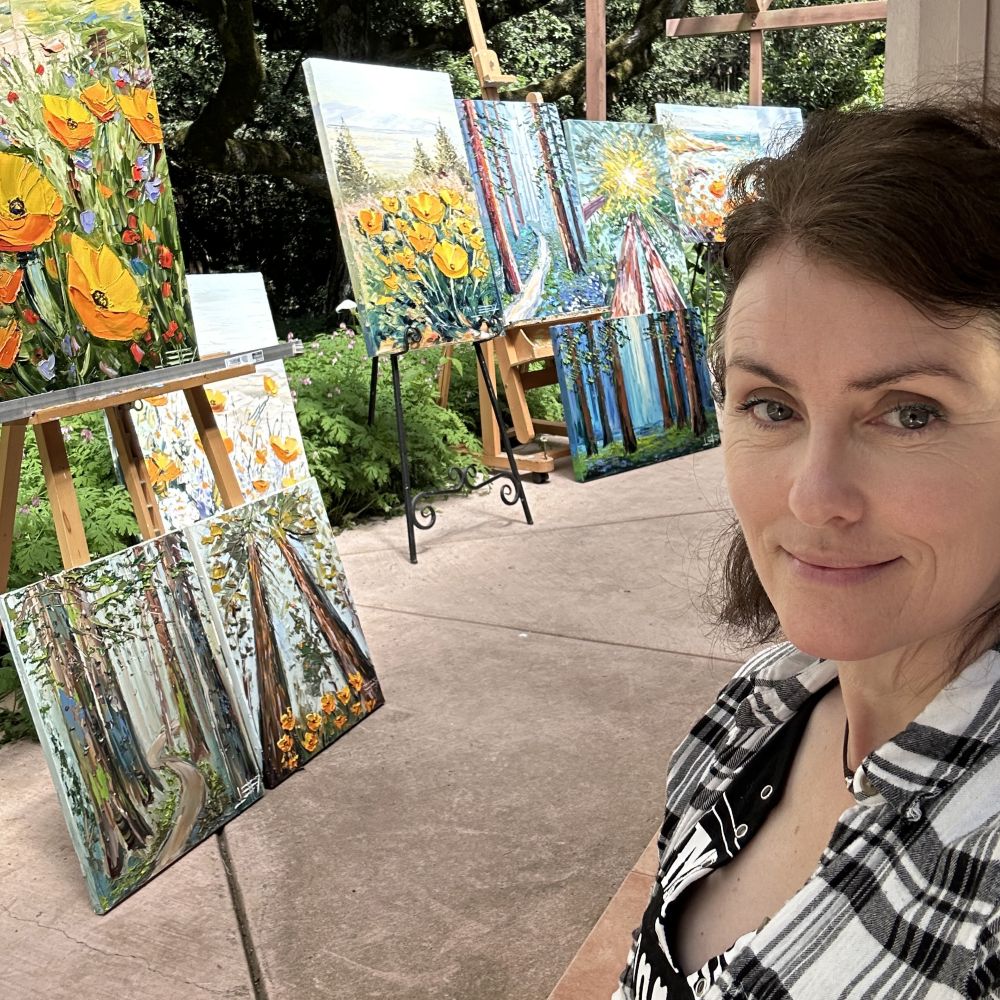 UGallery artist Lisa Elley with some of her impressionist paintings 