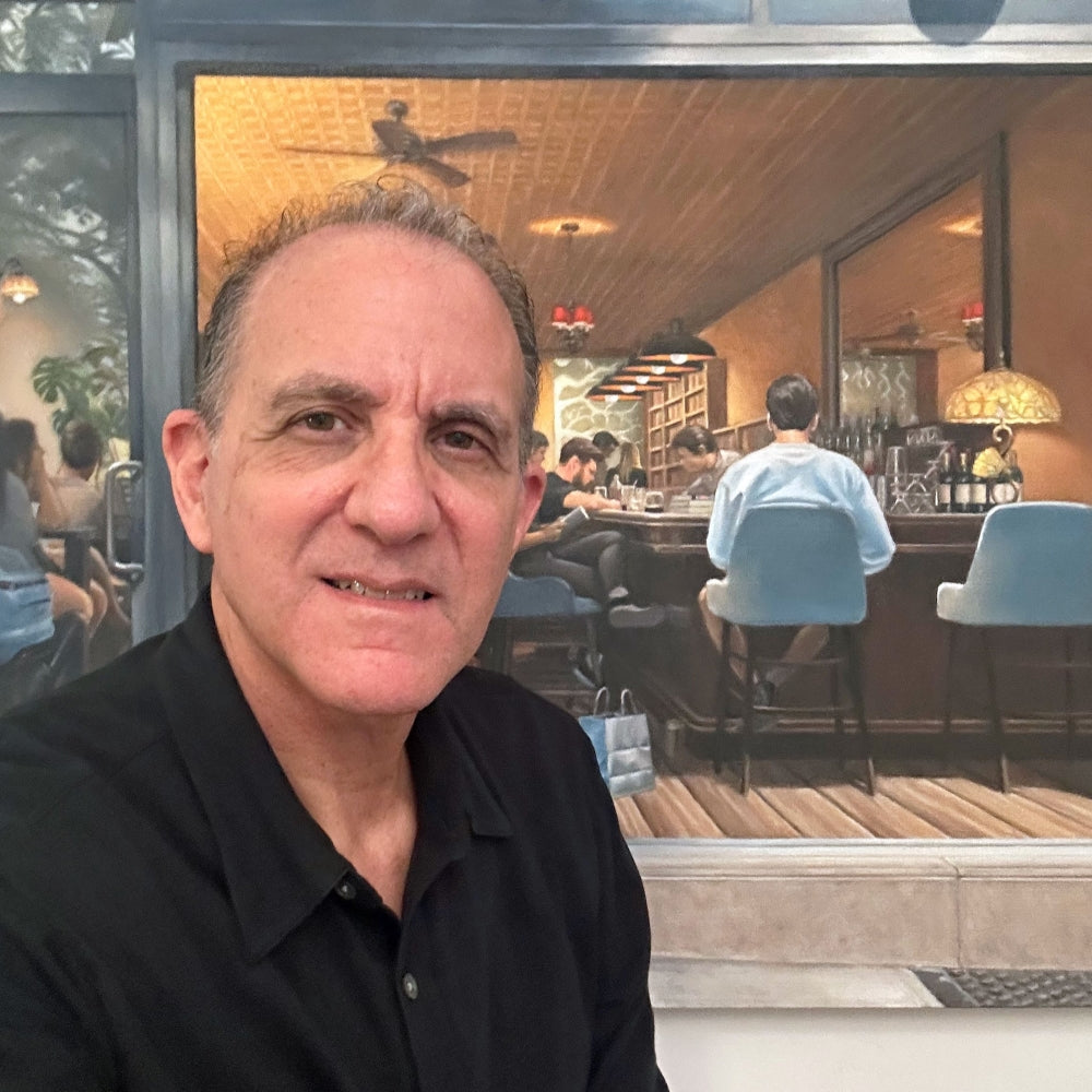  UGallery artist Nick Savides in front of his painting 