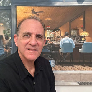  UGallery artist Nick Savides in front of his painting 