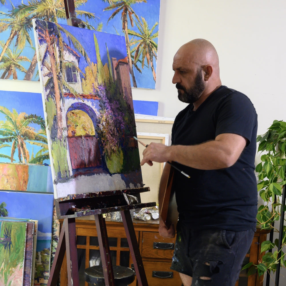  UGallery artist Suren Nersisyan painting at his easel 