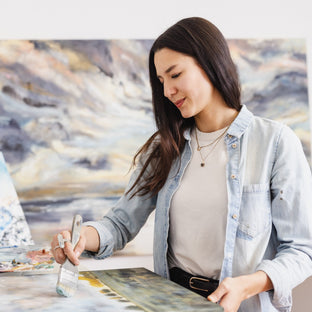  UGallery artist Tiffany Blaise working on a painting in her studio 
