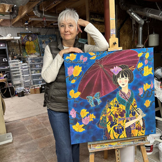  Artist Yelena Sidorova standing beside  a painting of a woman wearing a kimono and holding an umbrella 