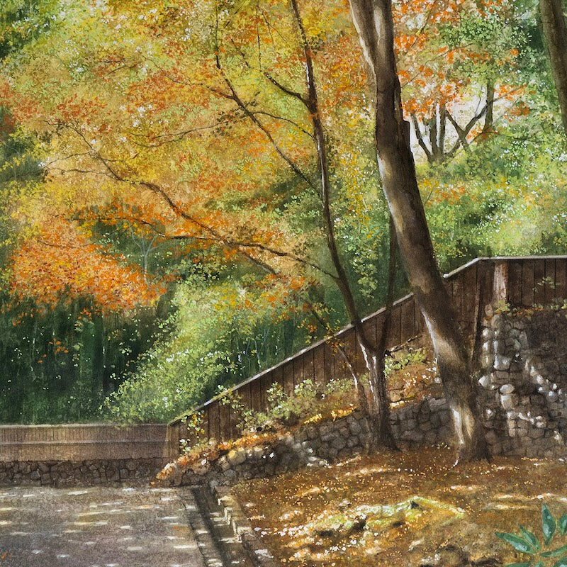  An autumn forest landscape painting by artist Masato Watanabe featuring trees with yellow, orange, and green foliage, a stone retaining wall, a wooden fence, and a paved path in the foreground. 