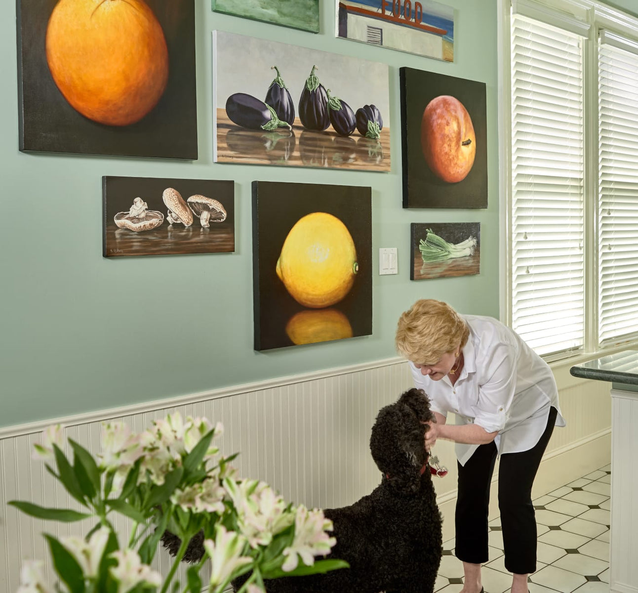  UGallery client in her kitchen with food-themed artwork 